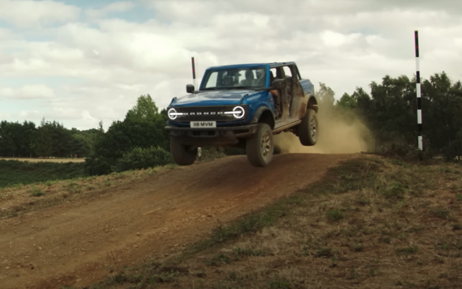 Ford Bronco mid jump on an off-road test track.